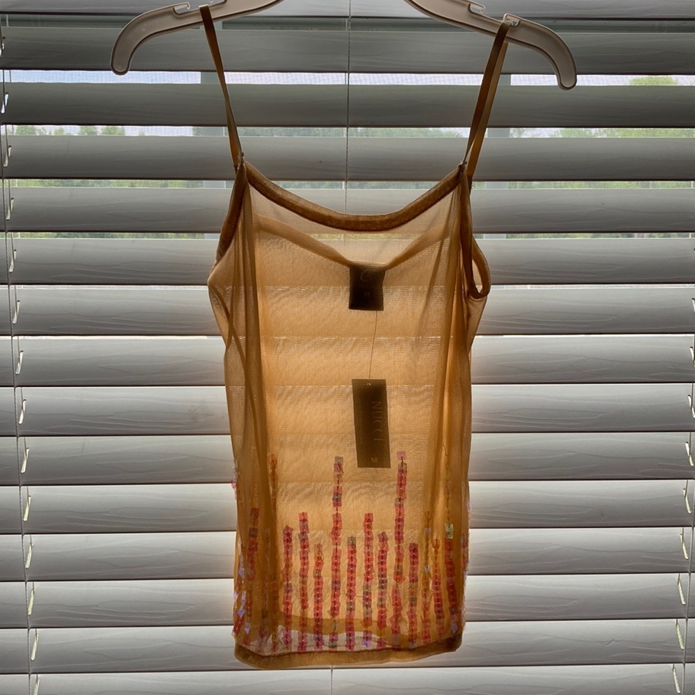 A tan see-through tank top with sparkles